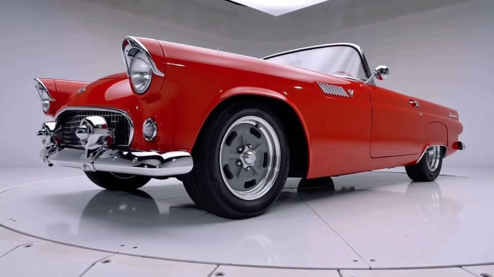 Low three-quarter front view of the Thunderbird in the studio, chrome bumper and front wheel in the foreground.