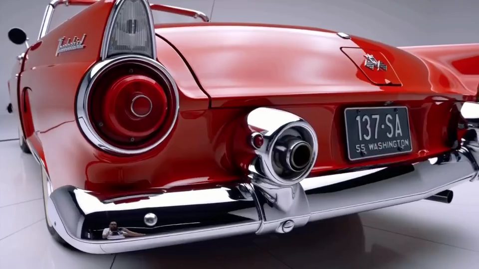 Rear three-quarter view of the Thunderbird in the studio, showing the tail fin, round tail light and twin chrome exhausts.
