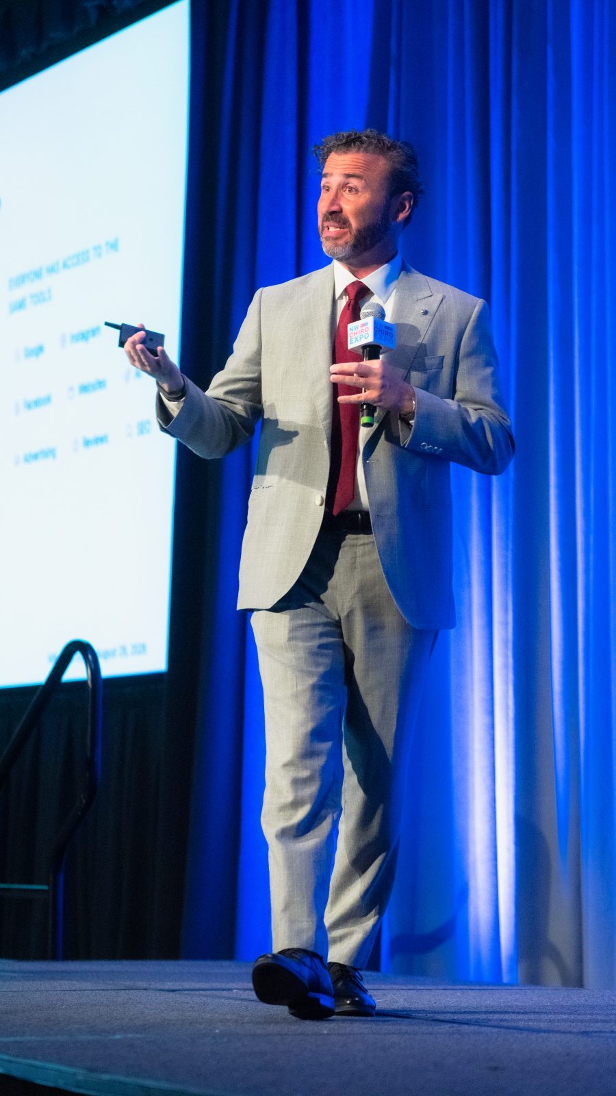 Josh Brumley speaking on the NW Chiro Expo main stage.