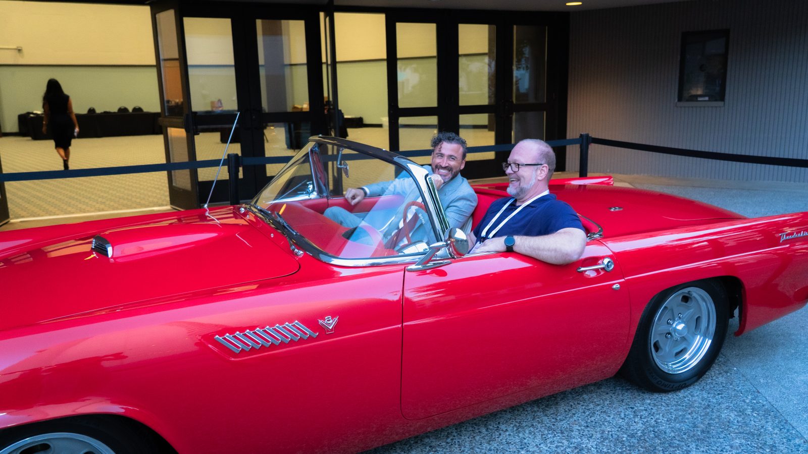 The winner and Josh Brumley laugh together in the front seat of the Thunderbird.